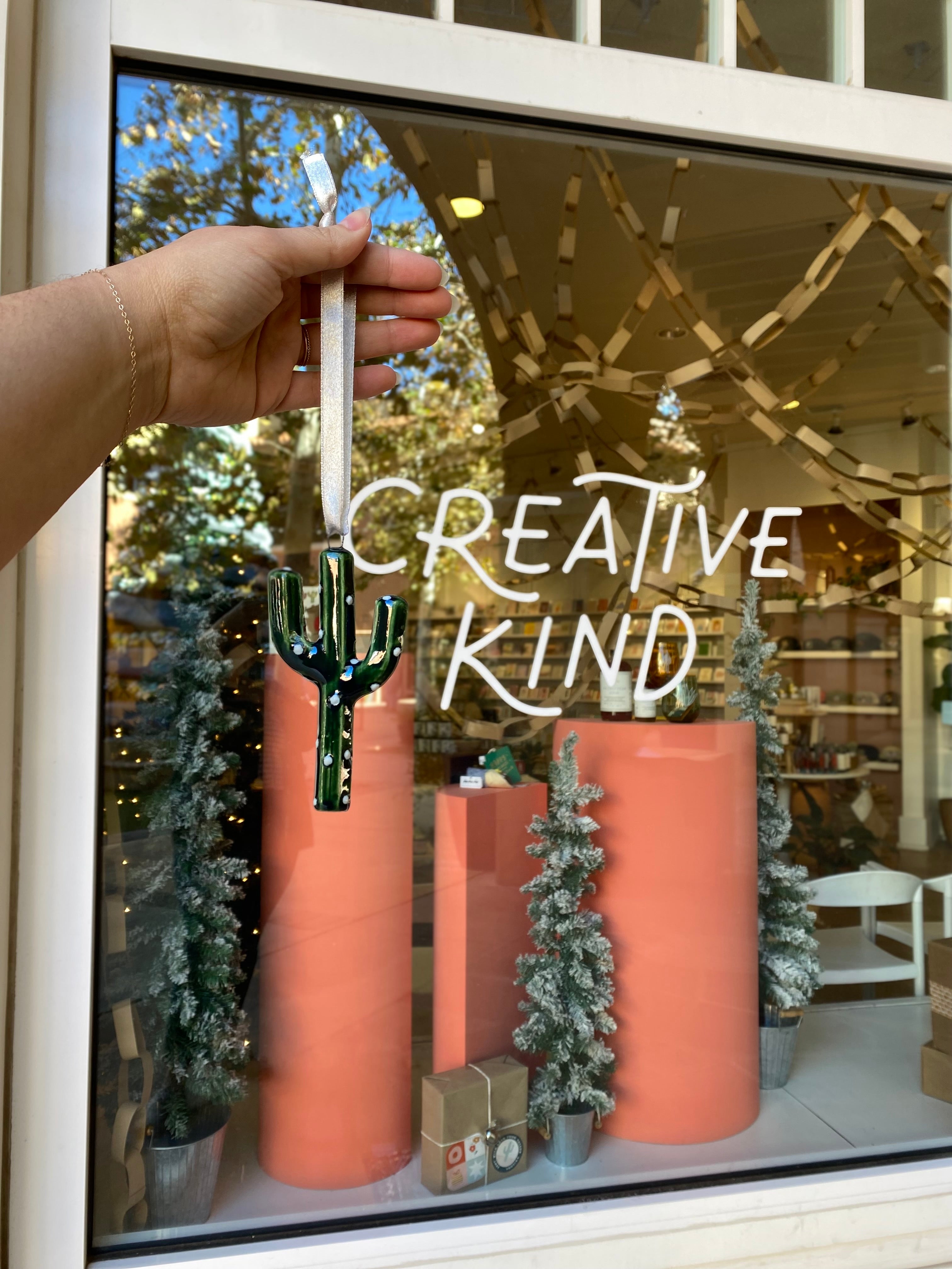 Small Shop Holiday Window with Winter Ornament