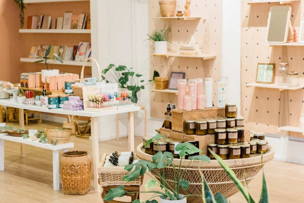 Bright shop interior with tables of gifts and plants