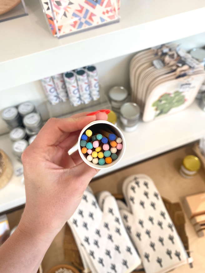 Person holding match container so that brightly tipped matches can be seen