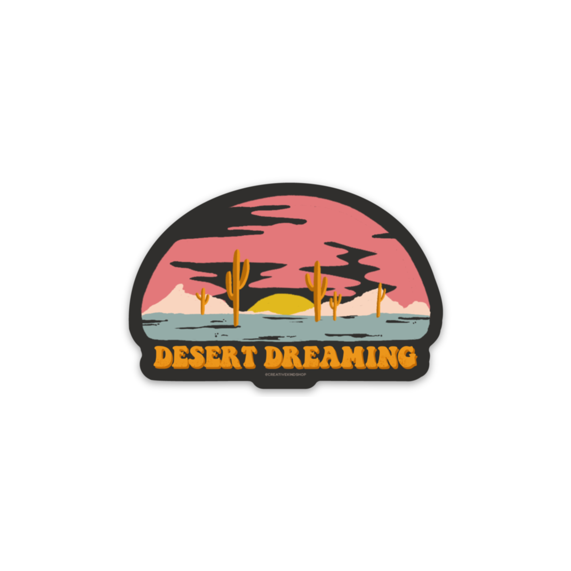 Black die cut sticker with desert sunset above the words "desert dreaming"