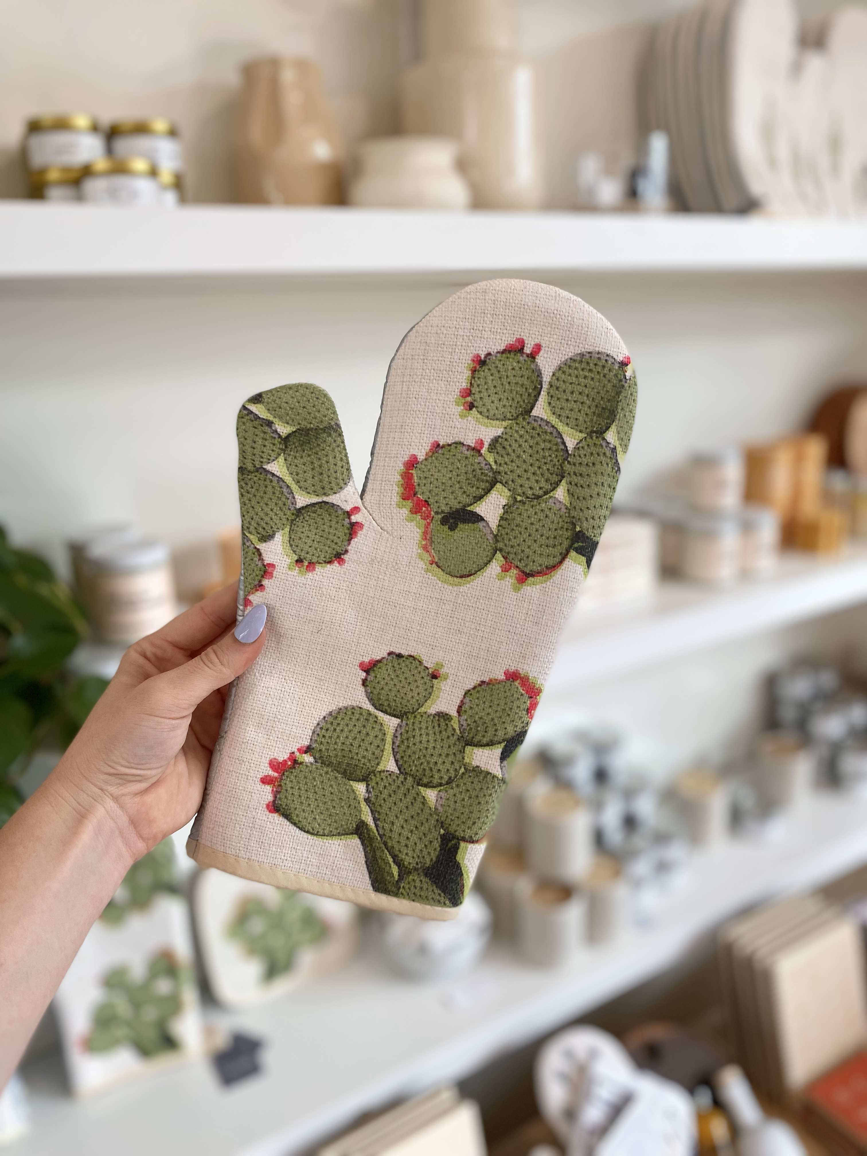 Person holding right handed prickly pear oven mitt