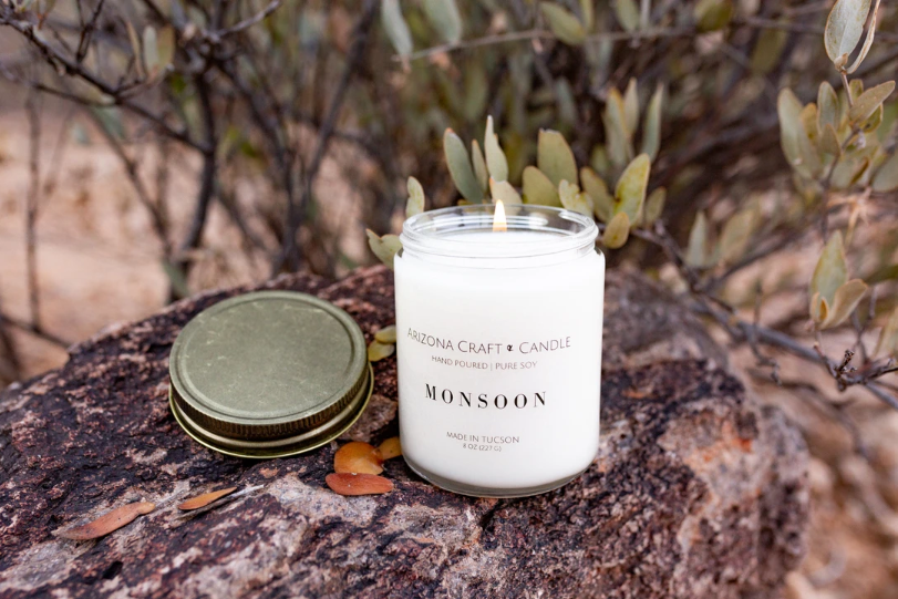Lit monsoon candle sitting on a rock in the desert