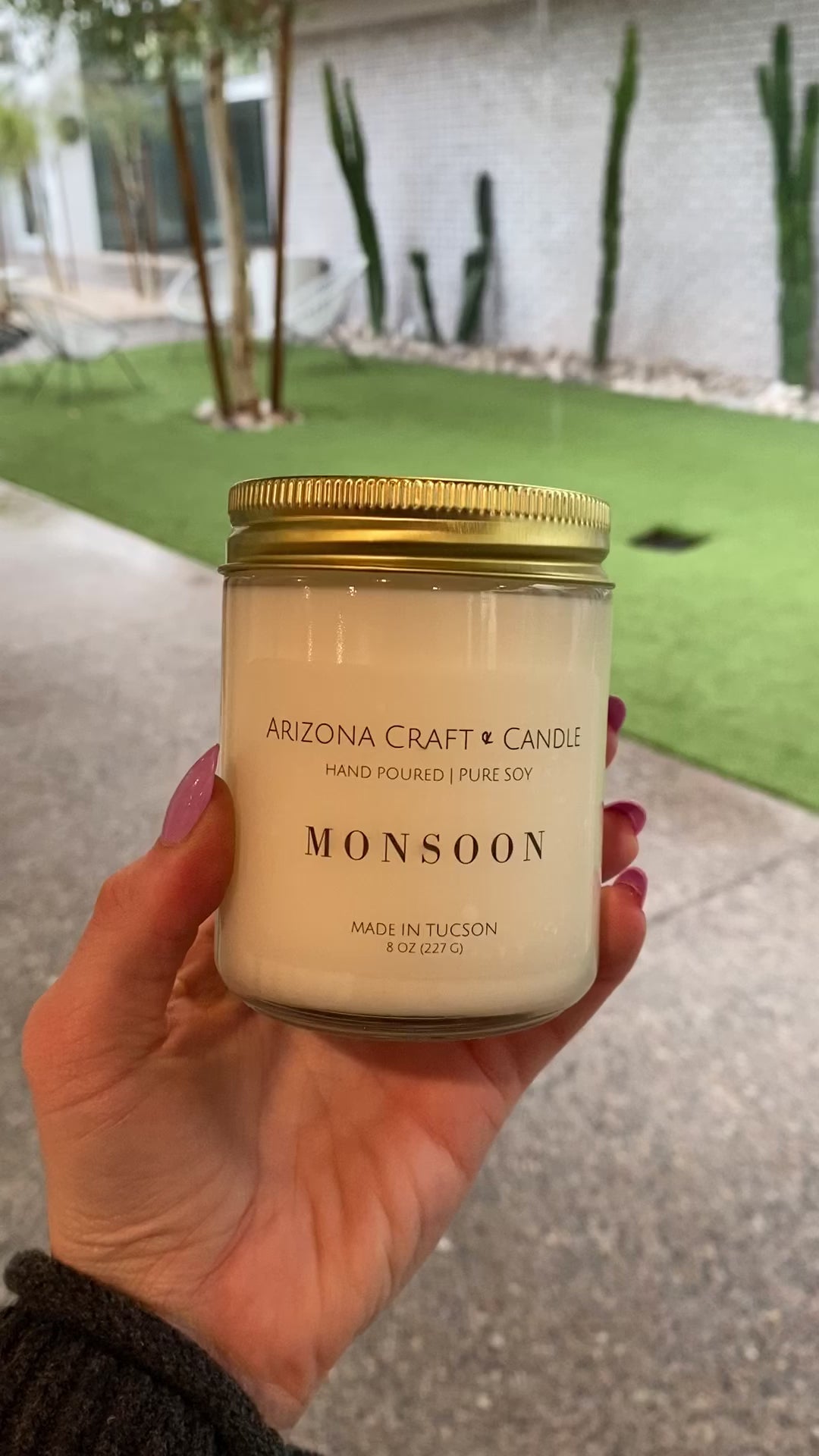 Monsoon candle being held with a real monsoon happening in the background of the video