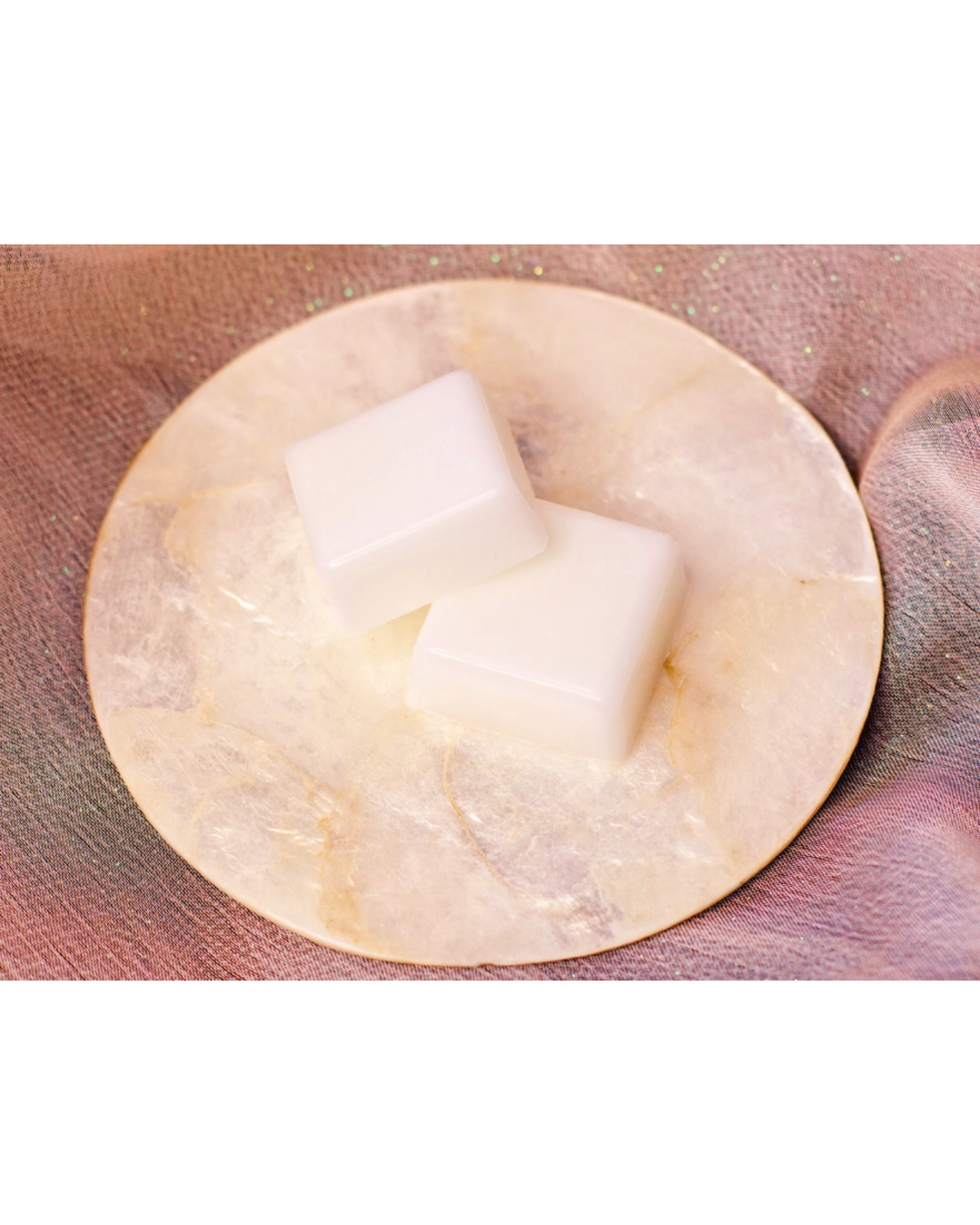 Two saguaro blossom wax melts sitting on a small plate