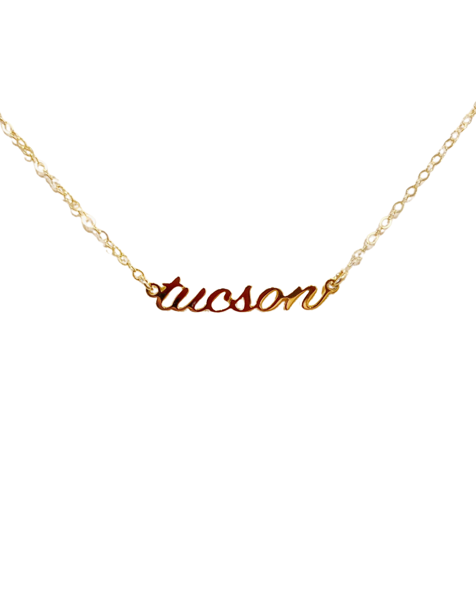 Close up of gold necklace with the word Tucson in cursive font with a gold chain