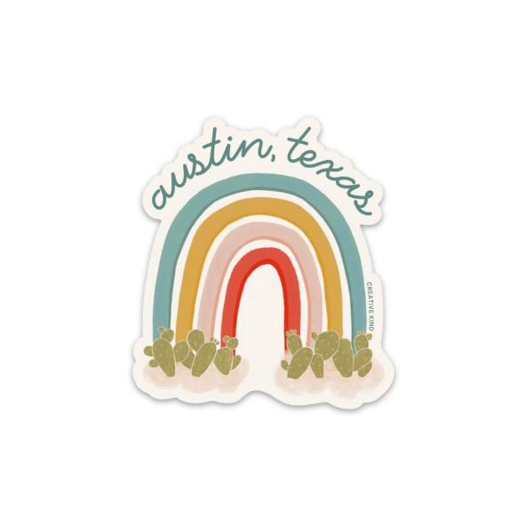 Die cut rainbow sticker of a rainbow with prickly pear cactus at the bottom of the rainbow and the words Austin, Texas in blue script above the rainbow