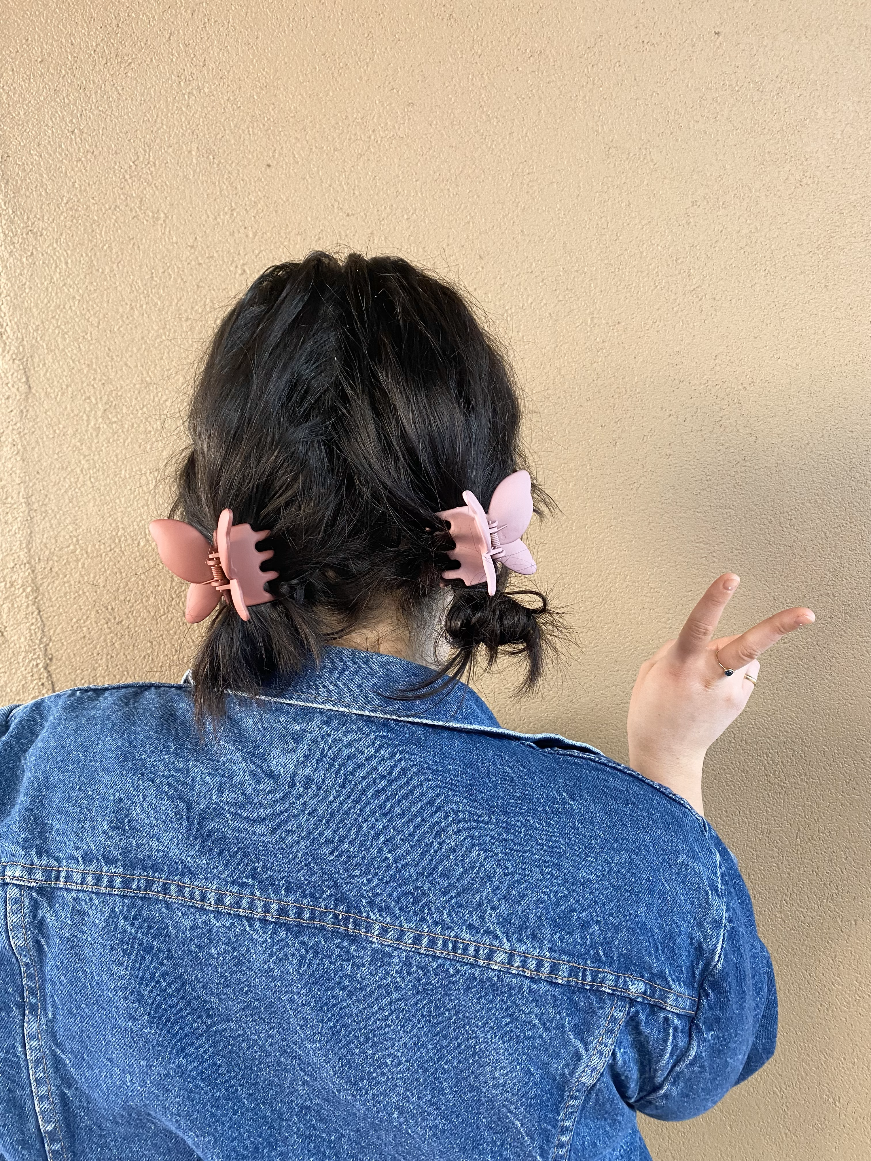Victoria wearing two small buns held up with plastic butterfly clips