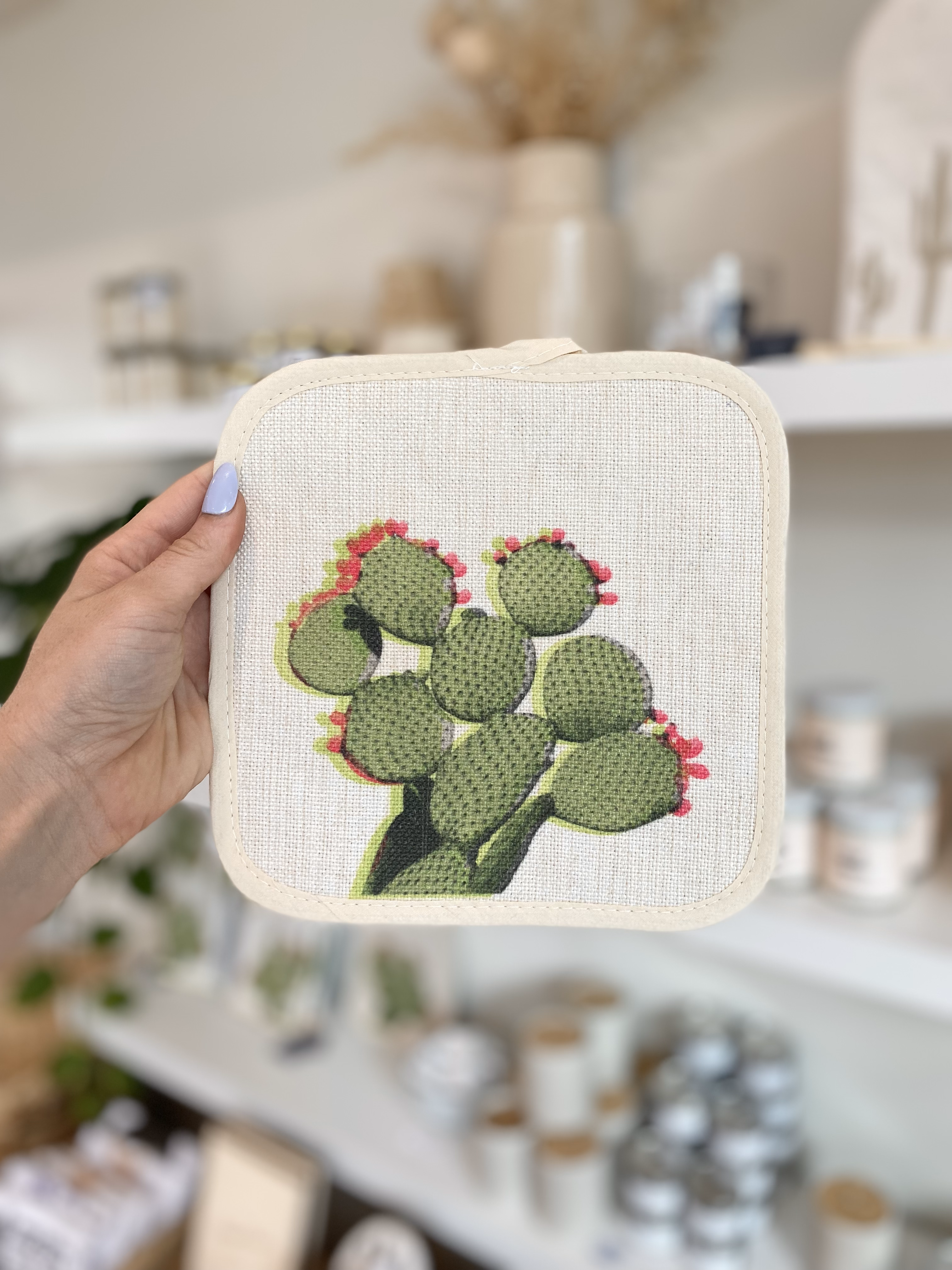Person holding prickly pear pot holder